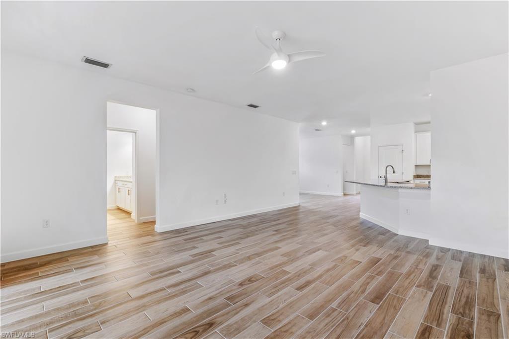 1817 Lema Court Naples, FL 34120 - Photo 10 of 22 a view of an empty room with wooden floor and a window