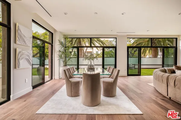 a dining room with furniture window and wooden floor