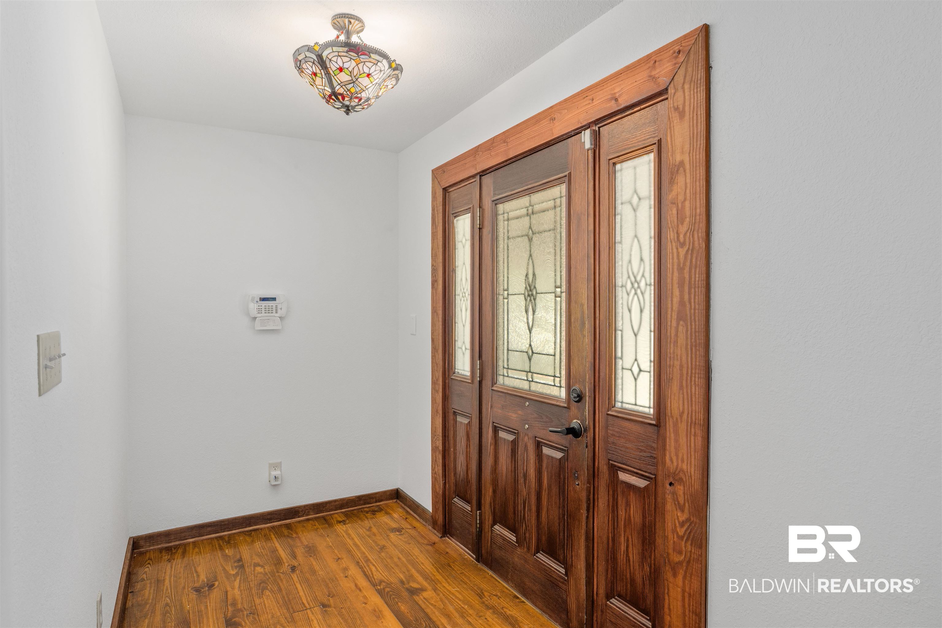 51699 Highway 31 Perdido, AL 36562 - Photo 16 of 30 Foyer entrance featuring baseboards and dark wood-style flooring