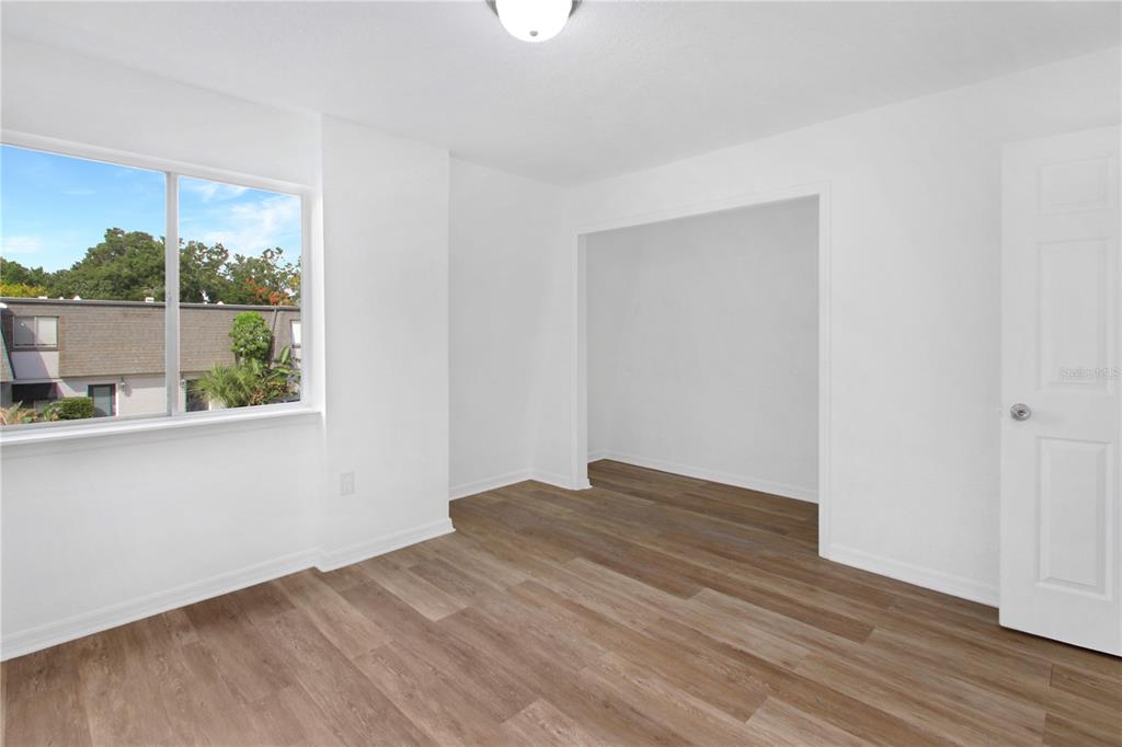 1946 South Conway Road, Unit 4 Orlando, FL 32812 - Photo 14 of 20 an empty room with wooden floor and windows