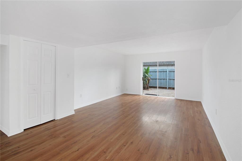 1946 South Conway Road, Unit 4 Orlando, FL 32812 - Photo 4 of 20 an empty room with wooden floor and windows