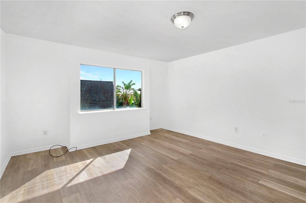1946 South Conway Road, Unit 4 Orlando, FL 32812 - Photo 10 of 20 an empty room with wooden floor and windows