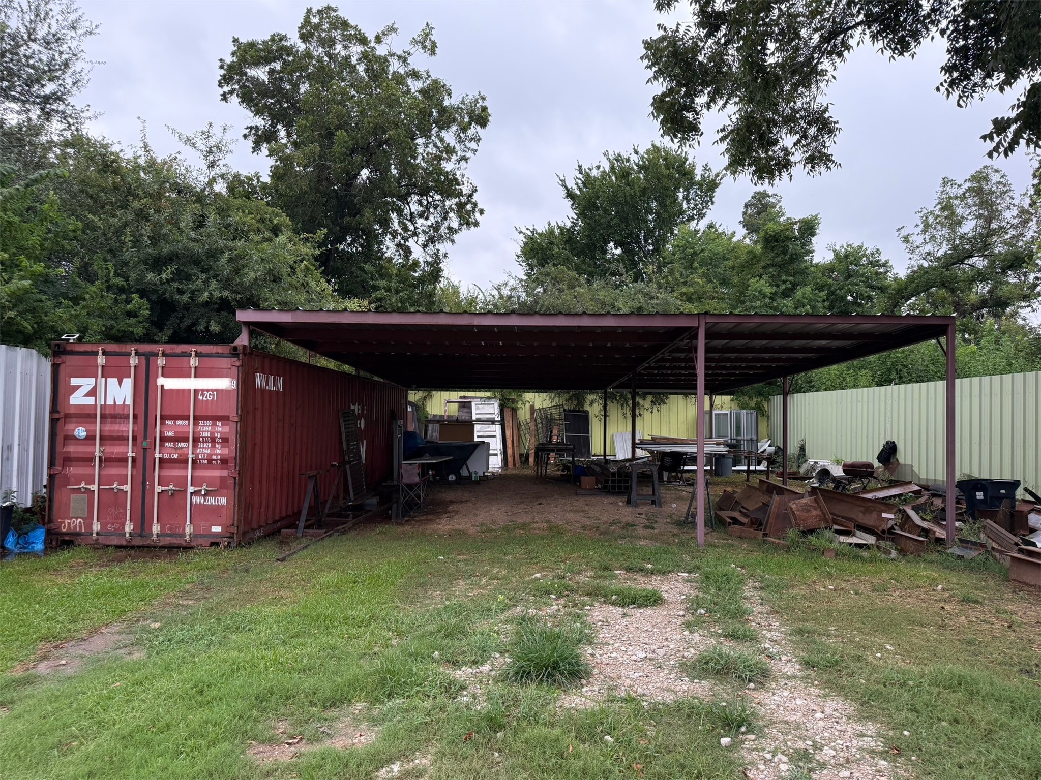 4217 East Toliver Street Houston, TX 77016 - Photo 5 of 6 a view of a patio with table and chairs under an umbrella with wooden fence