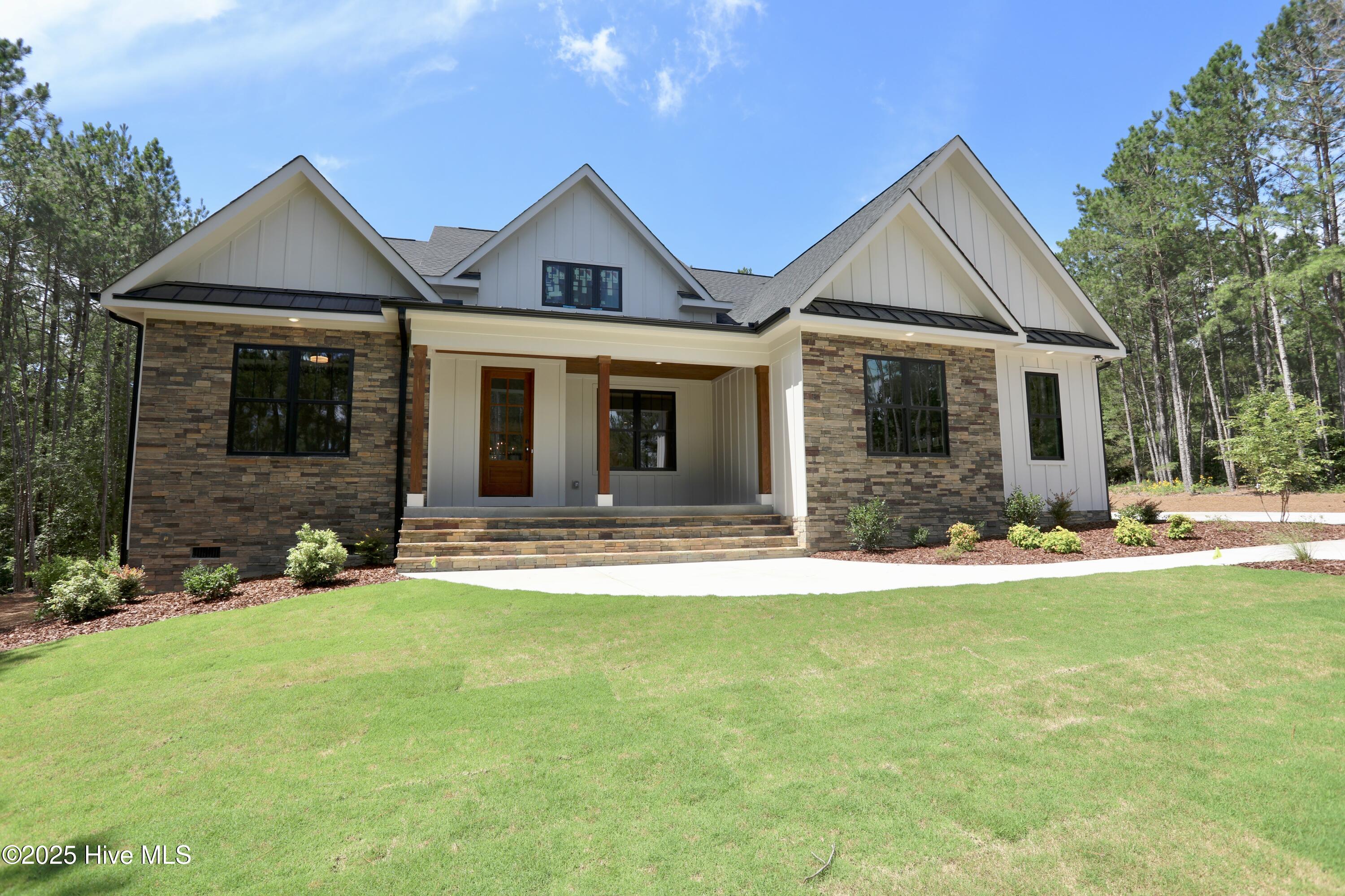 130 Gails Road West End, NC 27376 - Photo 1 of 61 GORGEOUS SETTING on 1-1/2 ac lot professionally landscaped with irrigation
