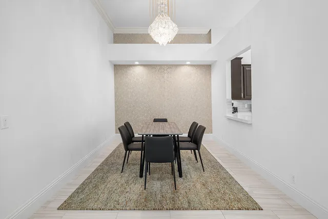 a living room with furniture potted plant and a large window