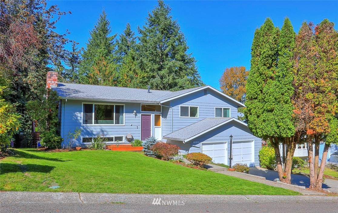21314 2nd Avenue Southeast Bothell, WA 98021 - Photo 2 of 25 a view of a yard in front of a house with plants and large tree