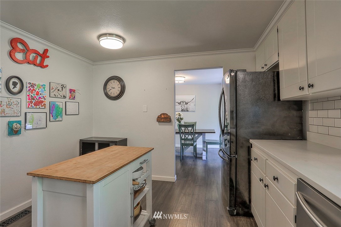 21314 2nd Avenue Southeast Bothell, WA 98021 - Photo 11 of 25 a kitchen with a refrigerator and a table