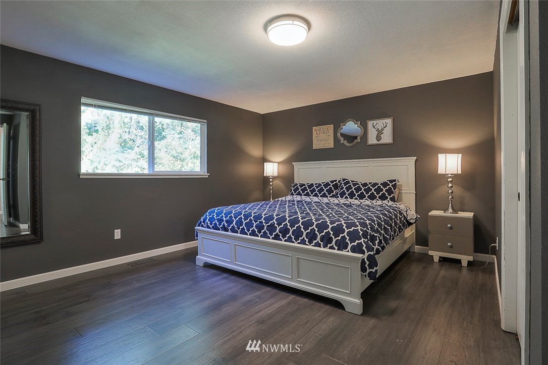 21314 2nd Avenue Southeast Bothell, WA 98021 - Photo 12 of 25 a bedroom with a bed and window