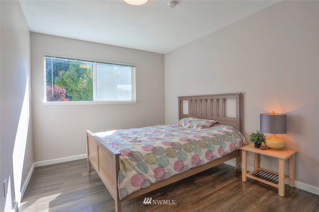 21314 2nd Avenue Southeast Bothell, WA 98021 - Photo 20 of 25 a bedroom with a bed and a table in it