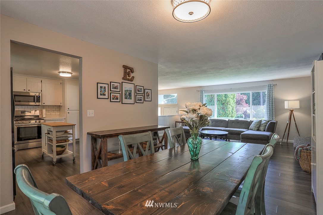 21314 2nd Avenue Southeast Bothell, WA 98021 - Photo 7 of 25 a view of a dining room and livingroom with furniture wooden floor a chandelier