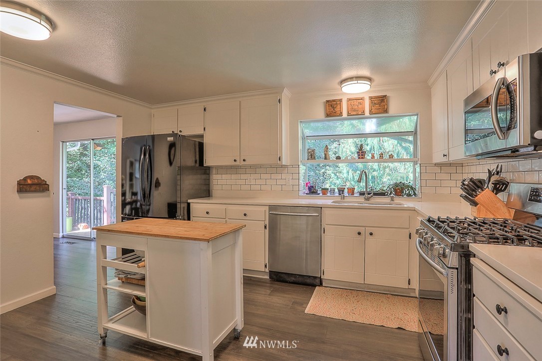 21314 2nd Avenue Southeast Bothell, WA 98021 - Photo 10 of 25 a kitchen with stainless steel appliances a stove a sink and a refrigerator