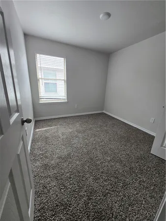 an empty room with a empty space and windows