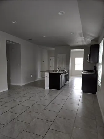 a kitchen with granite countertop a sink and stainless steel appliances