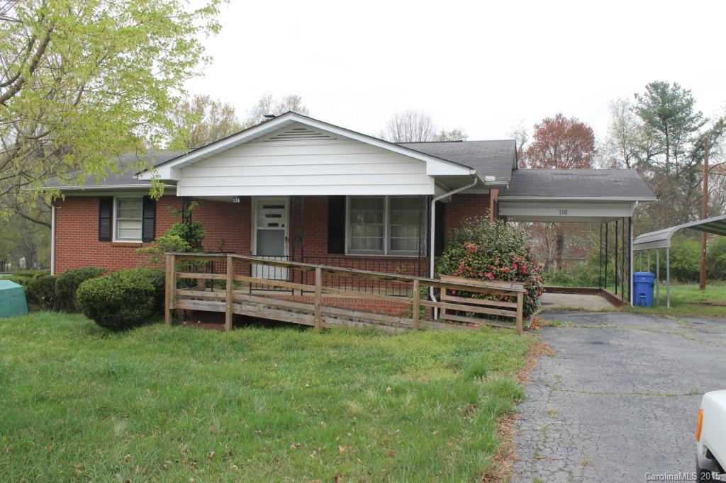 a view of a house with a yard wooden fence and a bench