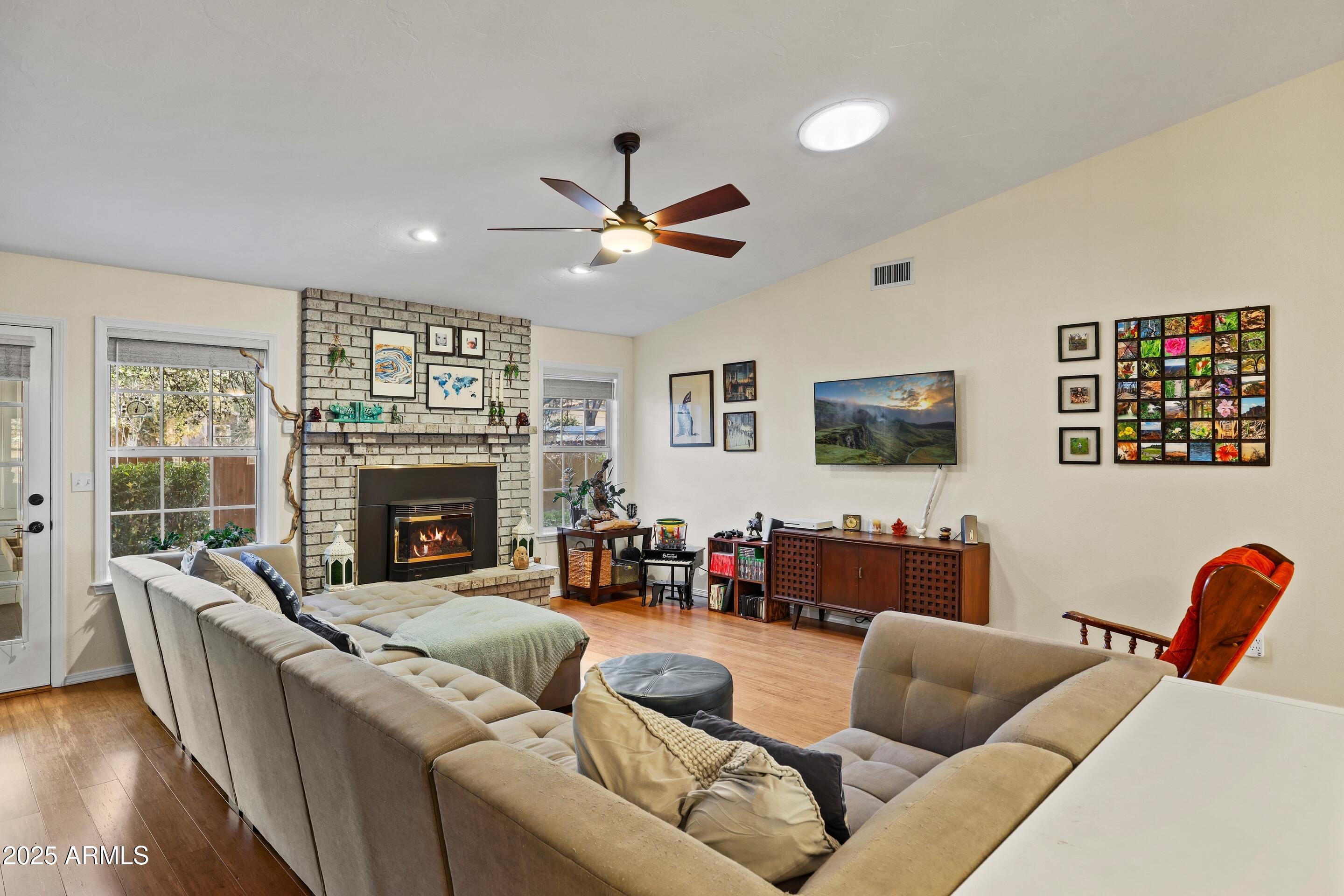 905 South Coronado Way Payson, AZ 85541 - Photo 5 of 33 a living room with furniture a fireplace and a flat screen tv