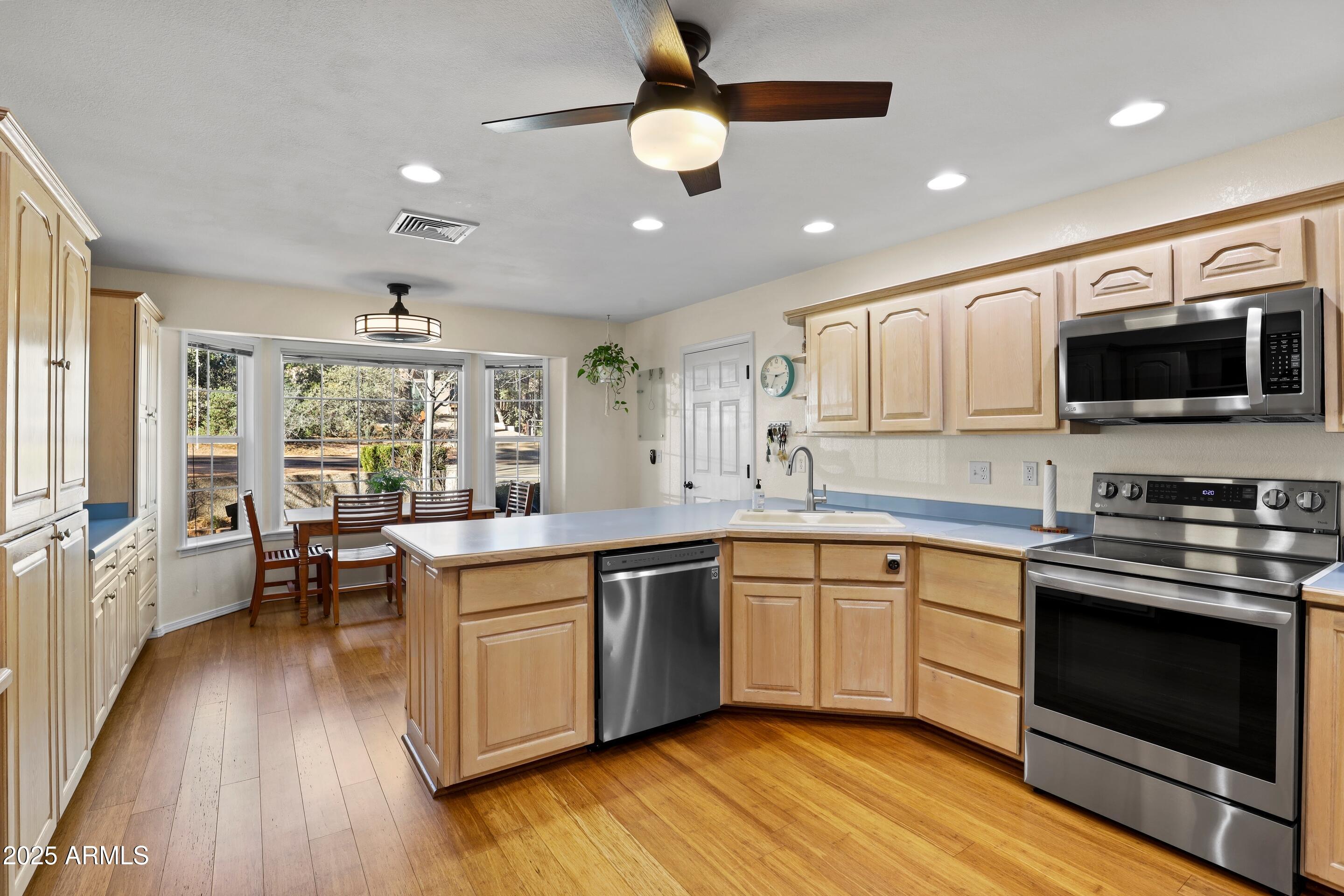 905 South Coronado Way Payson, AZ 85541 - Photo 8 of 33 a kitchen with stainless steel appliances granite countertop wooden floors and view living room