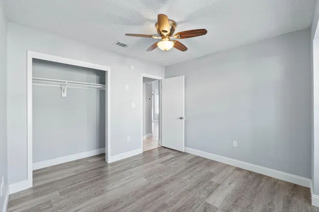 a view of an empty room with wooden floor