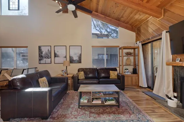 a living room with furniture a rug and a table