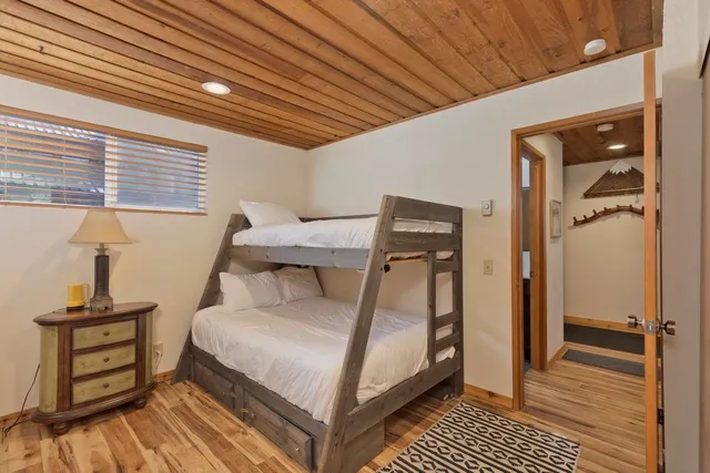 a bedroom with a bed and wooden floor