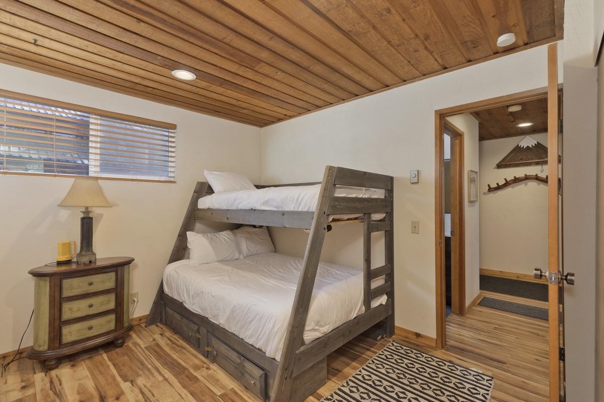175 Mammoth Slopes Drive, Unit 3 Mammoth Lakes, CA 93546 - Photo 13 of 30 a bedroom with a bed and wooden floor