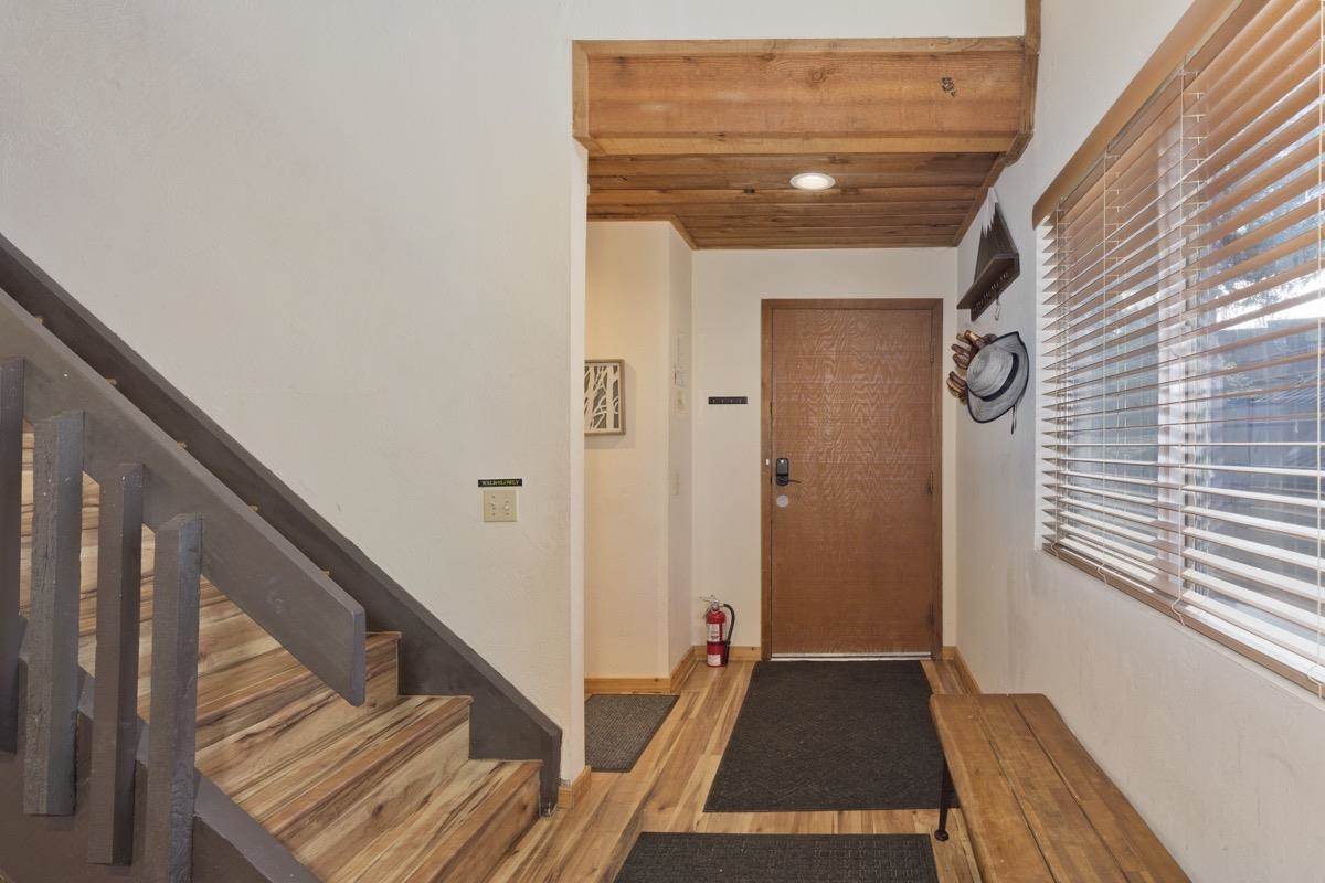 175 Mammoth Slopes Drive, Unit 3 Mammoth Lakes, CA 93546 - Photo 15 of 30 a view of a hallway with wooden floor and staircase
