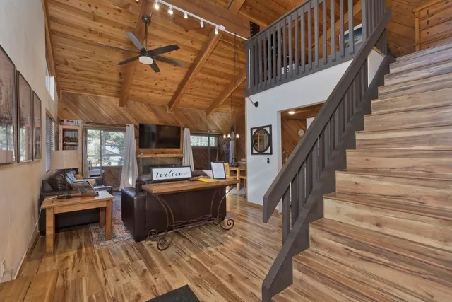 a view of entryway livingroom and hall with wooden floor