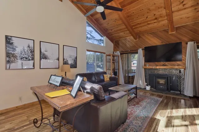 a living room with furniture a flat screen tv and a fireplace