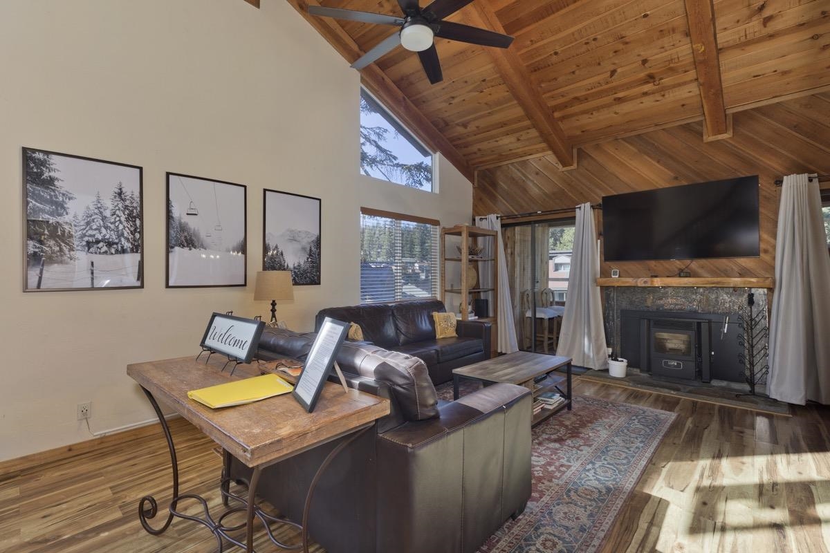 175 Mammoth Slopes Drive, Unit 3 Mammoth Lakes, CA 93546 - Photo 2 of 30 a living room with furniture a flat screen tv and a fireplace
