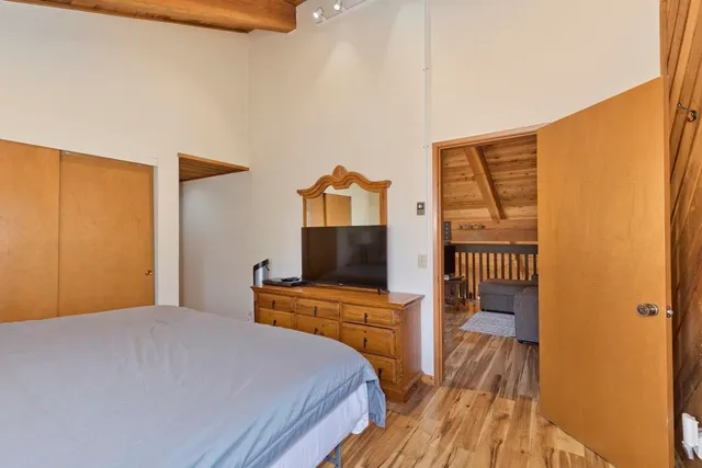 a bedroom with a bed and a flat screen tv