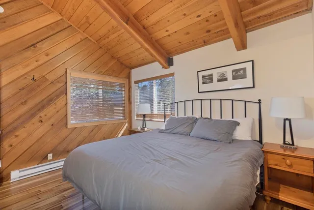 a bedroom with a large bed and a window