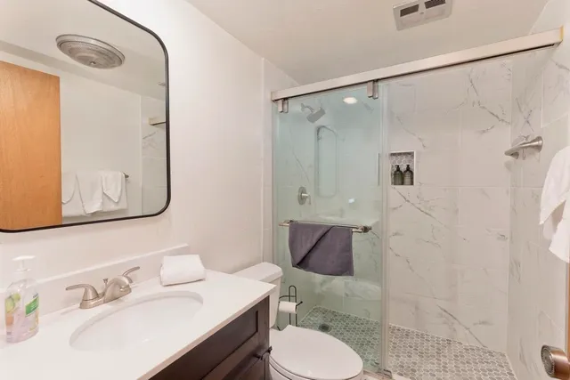 a bathroom with a sink toilet and shower