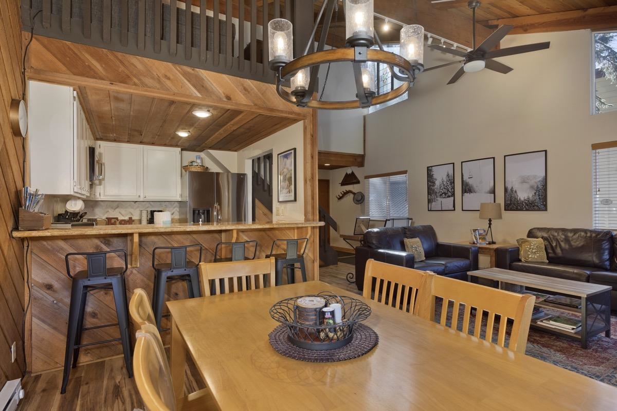 175 Mammoth Slopes Drive, Unit 3 Mammoth Lakes, CA 93546 - Photo 5 of 30 a open kitchen with stainless steel appliances kitchen island granite countertop a table and chairs