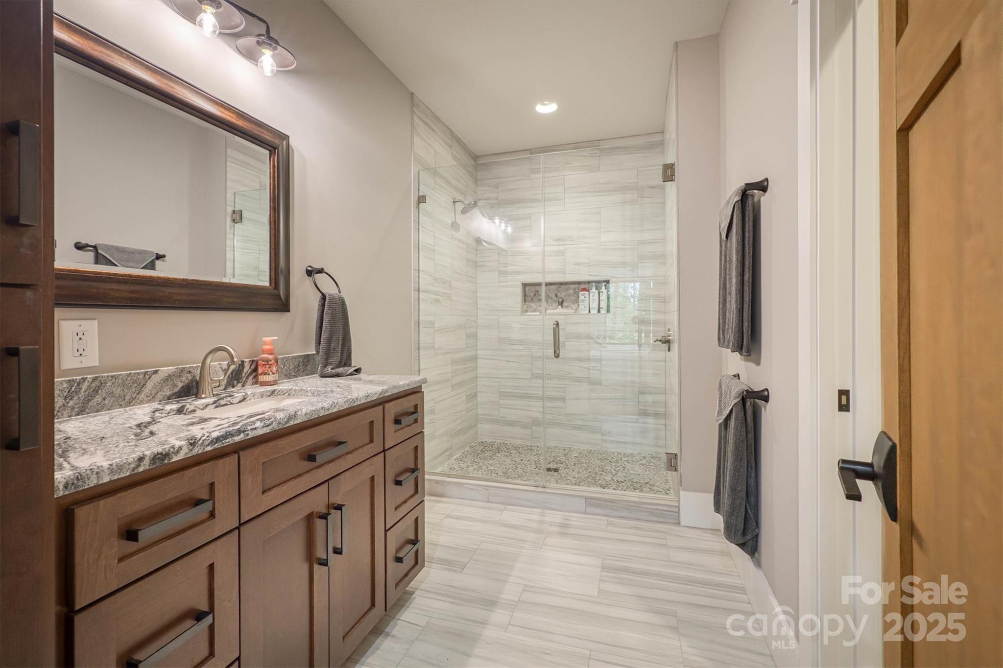 2116 October Drive, Unit 146 Nebo, NC 28761 - Photo 34 of 45 a bathroom with a granite countertop sink mirror and double
