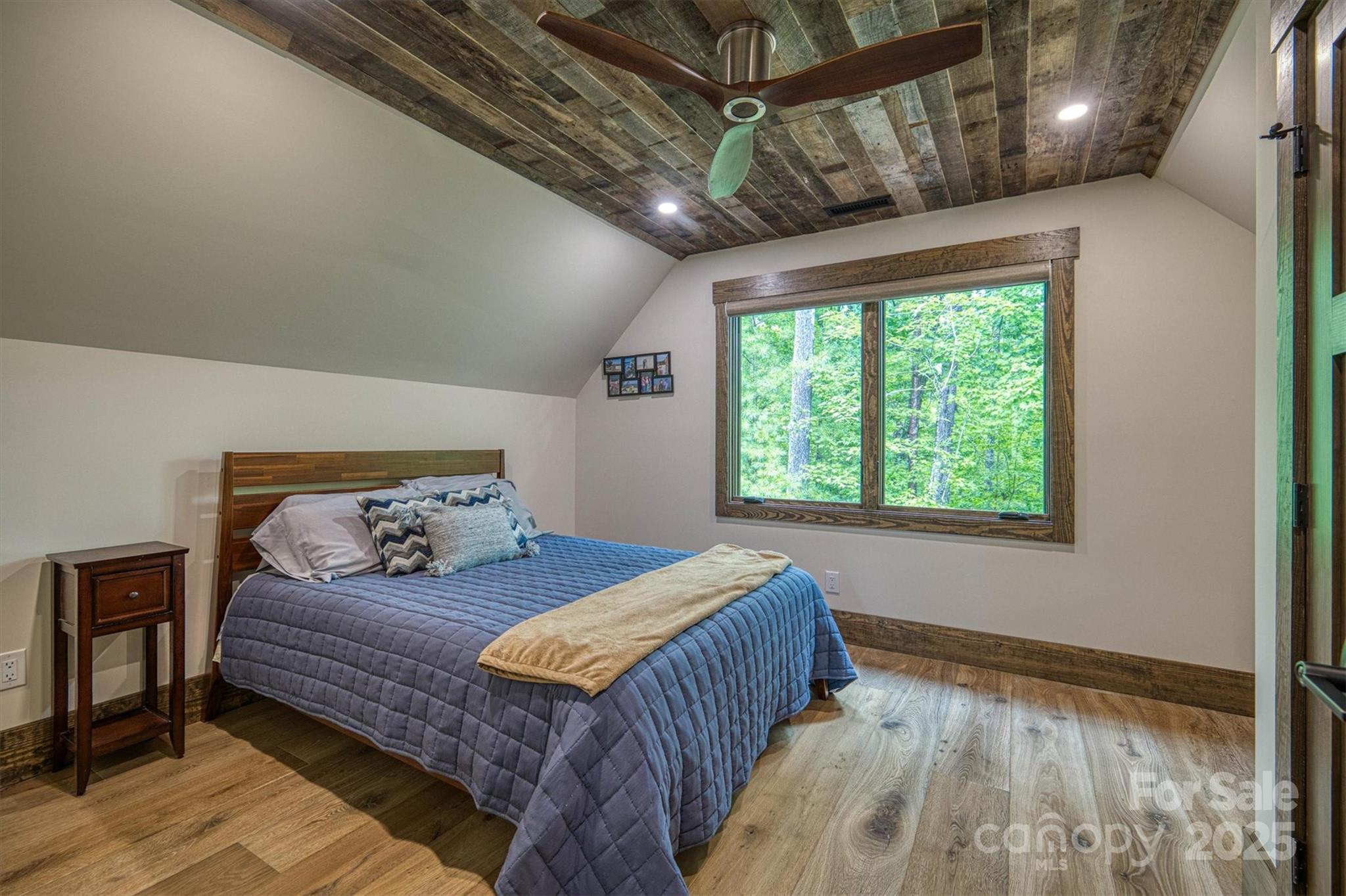 2116 October Drive, Unit 146 Nebo, NC 28761 - Photo 39 of 45 a bedroom with a bed and wooden floor