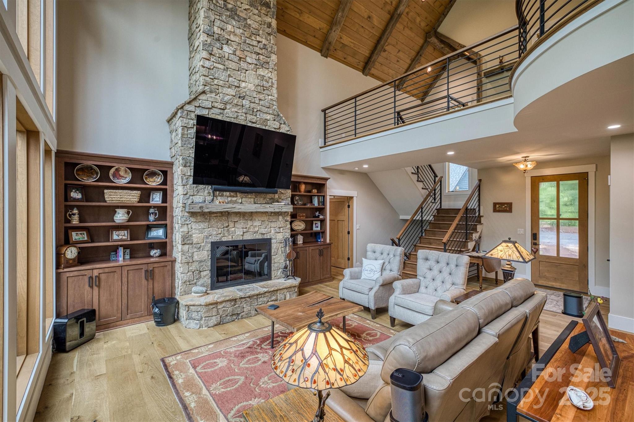 2116 October Drive, Unit 146 Nebo, NC 28761 - Photo 7 of 45 a living room with furniture a flat screen tv and a fireplace