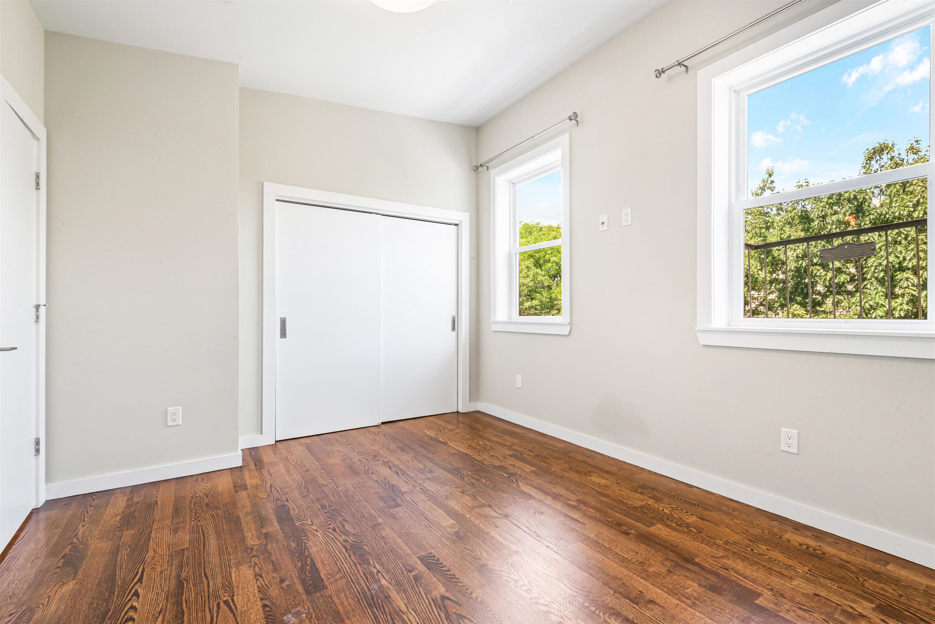102 Colgate Street, Unit 302 Jersey City, NJ 07302 - Photo 18 of 21 an empty room with wooden floor and a window