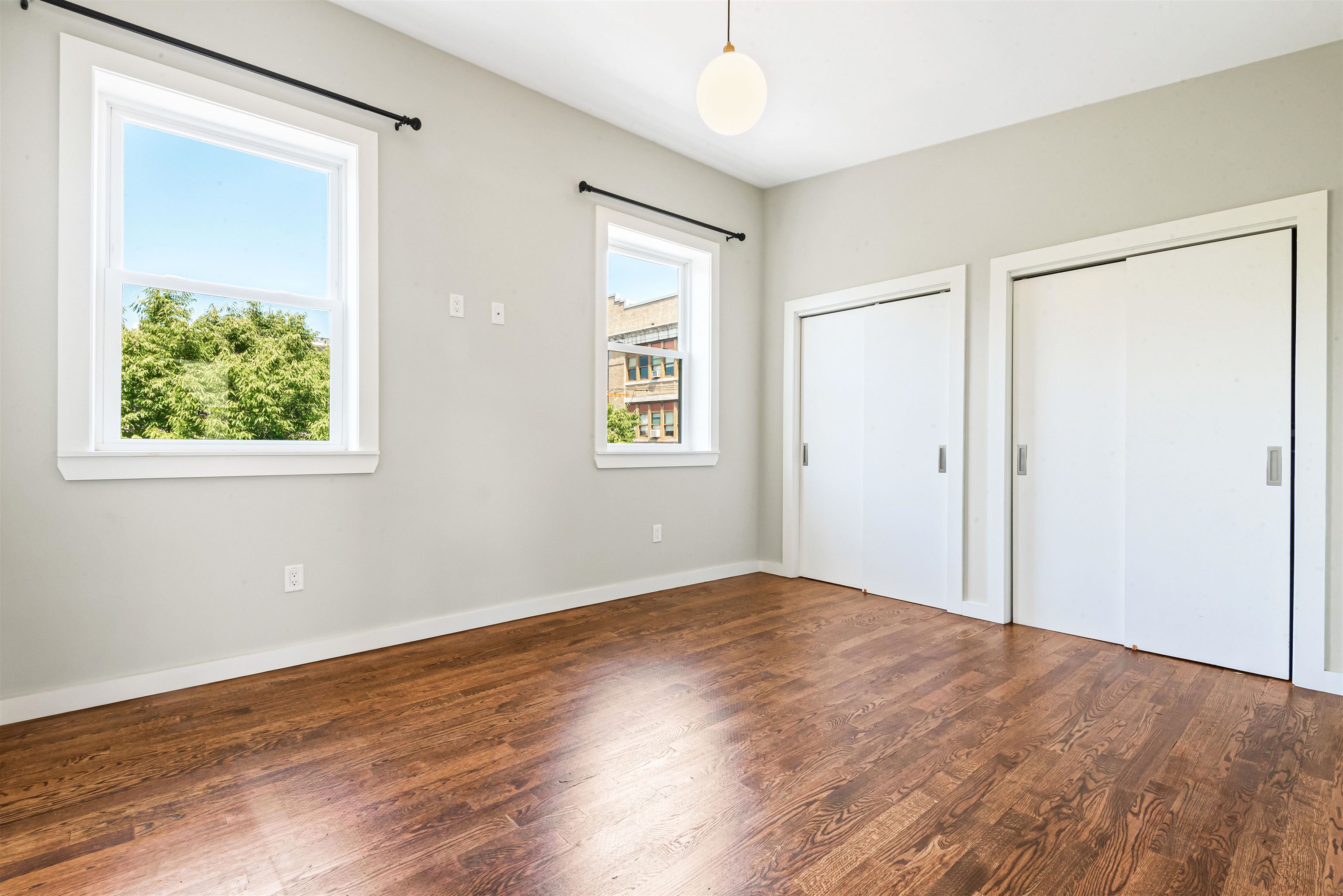 102 Colgate Street, Unit 302 Jersey City, NJ 07302 - Photo 19 of 21 a view of an empty room with wooden floor and a window