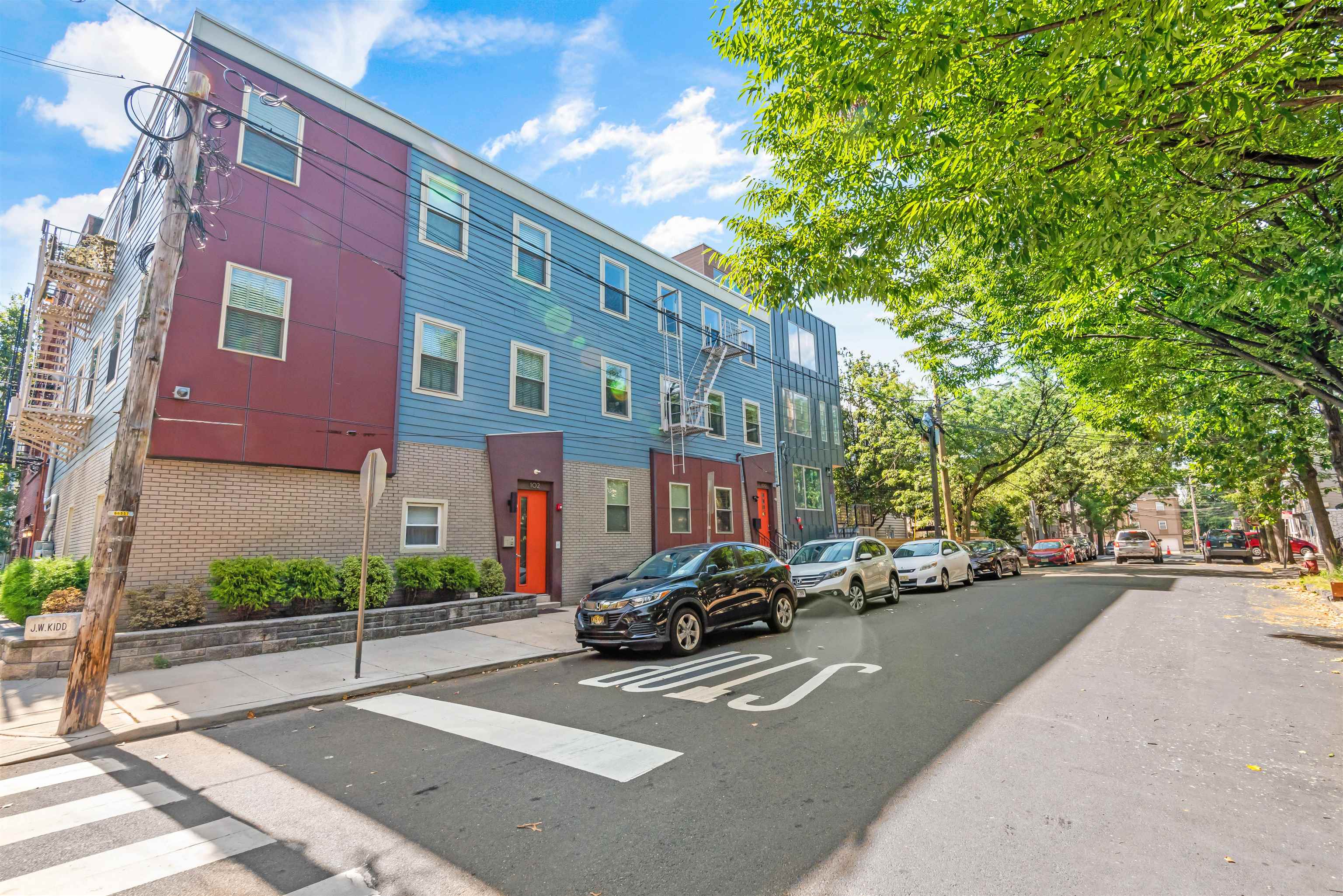 102 Colgate Street, Unit 302 Jersey City, NJ 07302 - Photo 2 of 21 a city street lined with buildings and cars