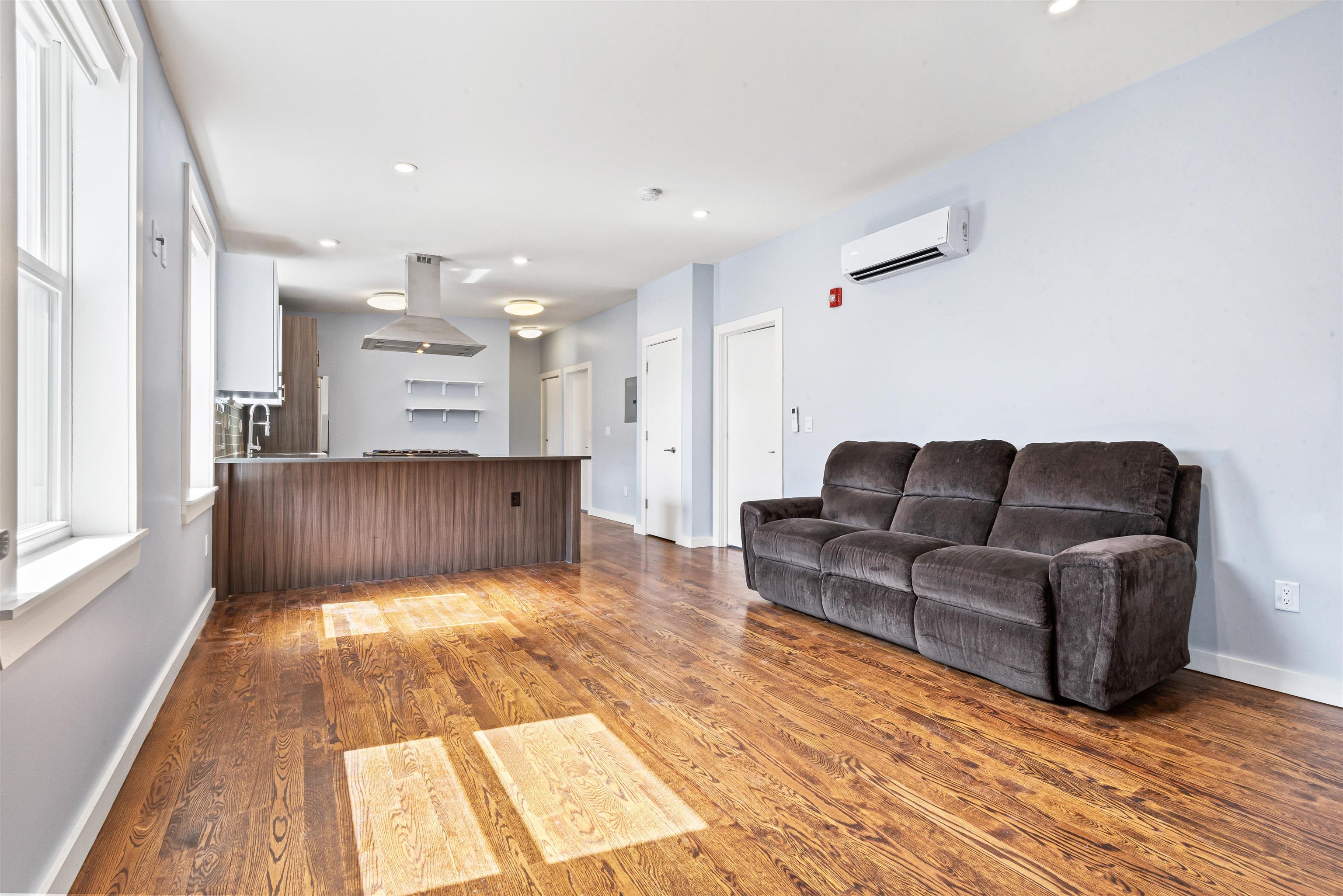 102 Colgate Street, Unit 302 Jersey City, NJ 07302 - Photo 5 of 21 a living room with furniture and kitchen view