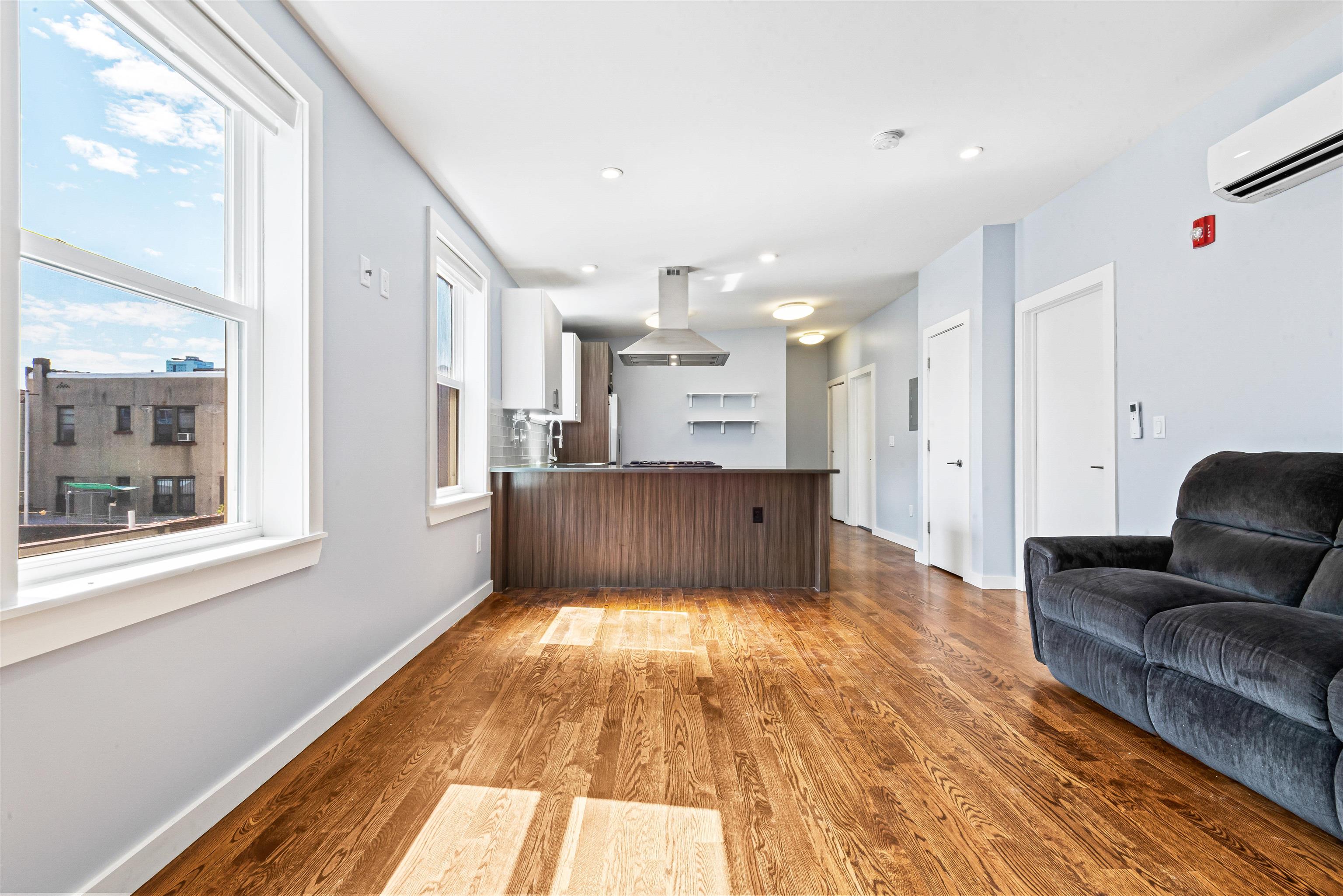 102 Colgate Street, Unit 302 Jersey City, NJ 07302 - Photo 6 of 21 a view of kitchen with livingroom and furniture