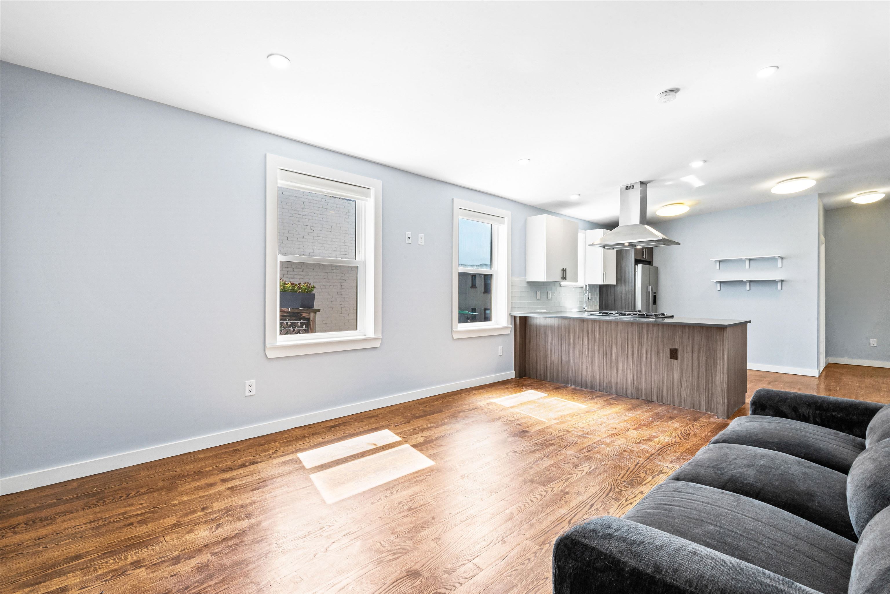 102 Colgate Street, Unit 302 Jersey City, NJ 07302 - Photo 7 of 21 a view of kitchen with furniture and wooden floor