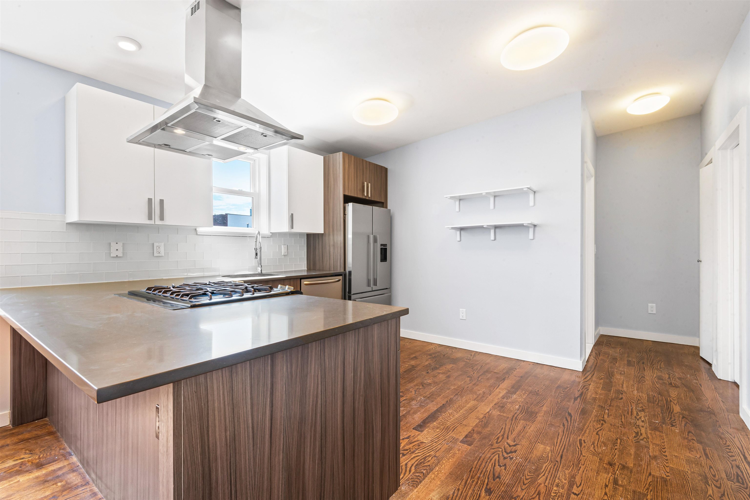 102 Colgate Street, Unit 302 Jersey City, NJ 07302 - Photo 8 of 21 a kitchen with a stove a refrigerator and a sink