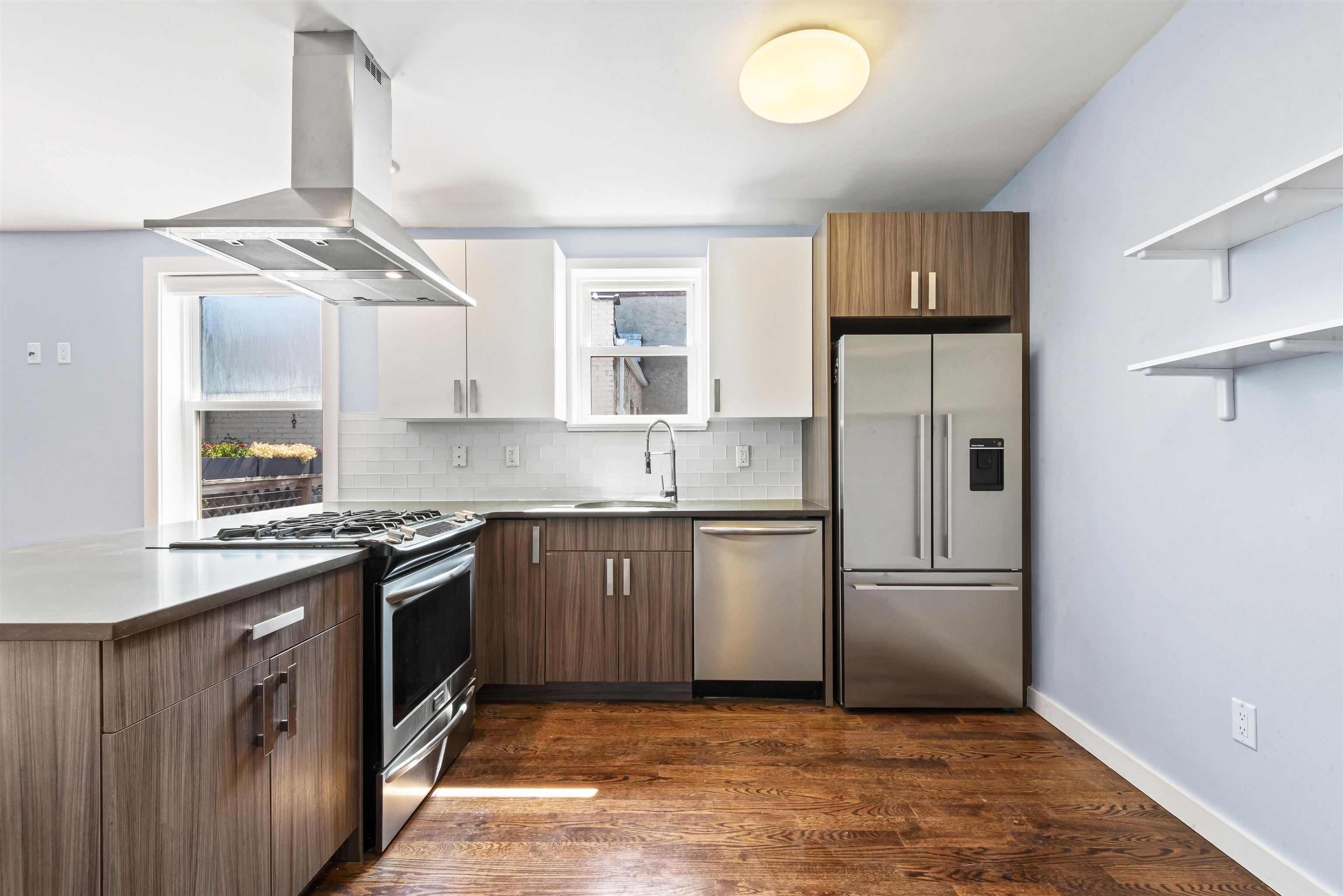 102 Colgate Street, Unit 302 Jersey City, NJ 07302 - Photo 10 of 21 a kitchen with stainless steel appliances granite countertop a refrigerator and a sink
