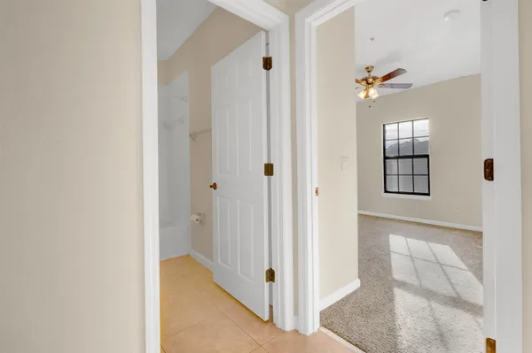 a view of a hallway with wooden floor and closet