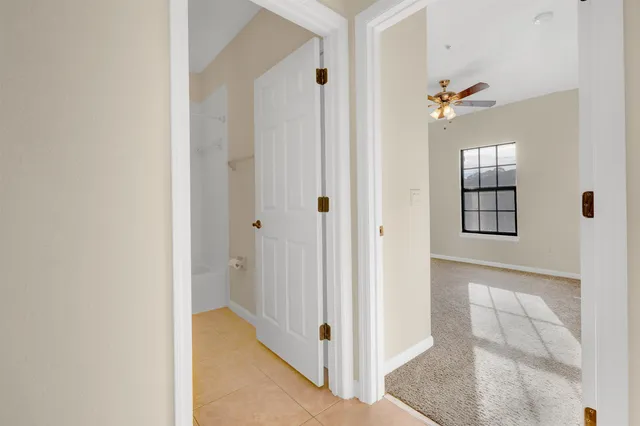 a view of a hallway with wooden floor and closet