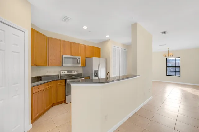a kitchen with stainless steel appliances granite countertop a sink and cabinets