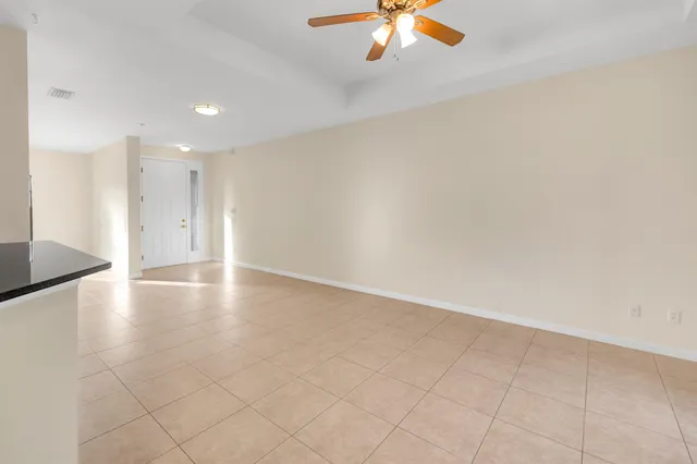 an empty room with wooden floor and chandelier
