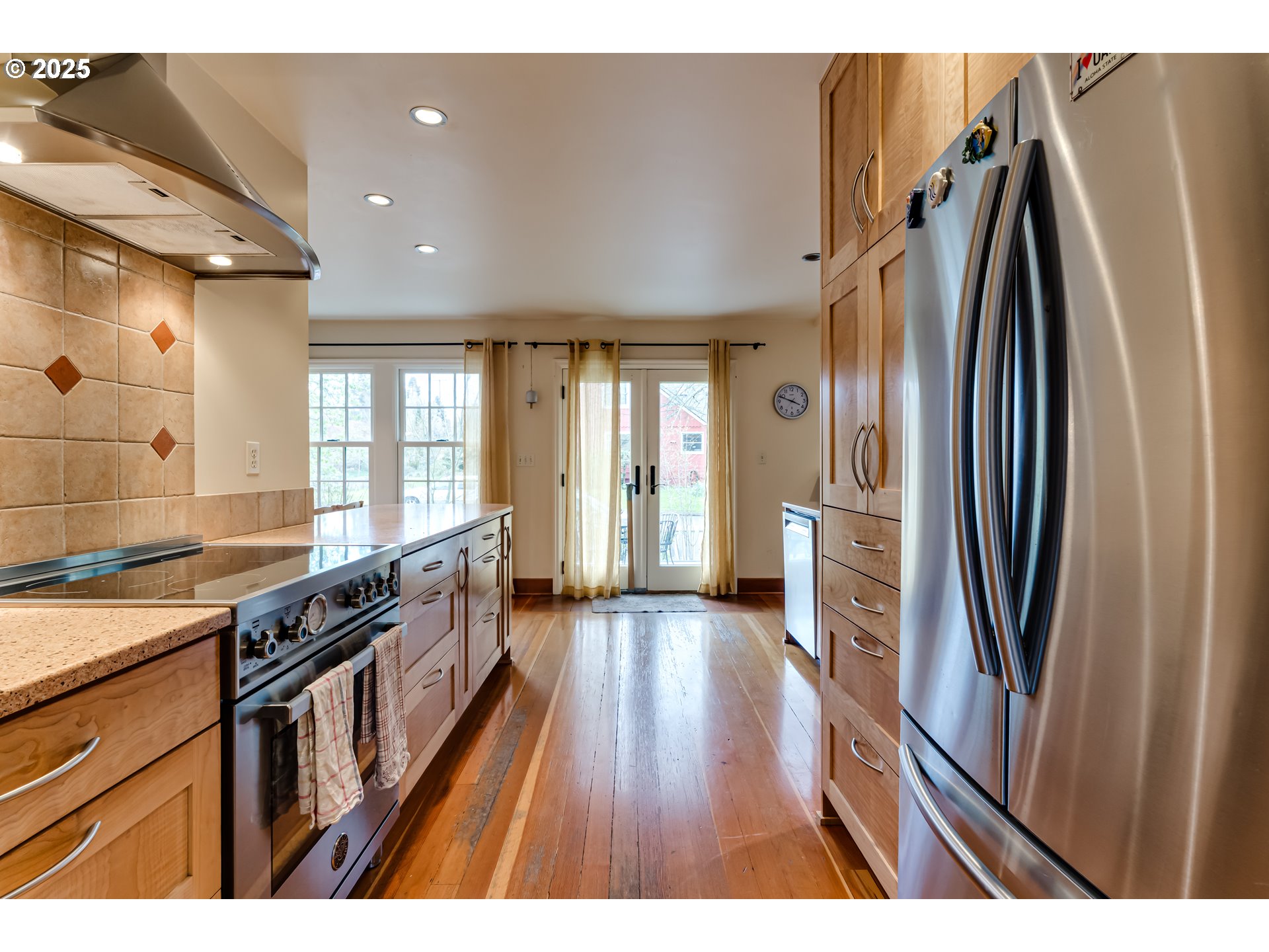 1996 Monroe Street Eugene, OR 97405 - Photo 13 of 47 a kitchen with stainless steel appliances granite countertop a refrigerator a sink dishwasher a stove and white countertops with wooden floor