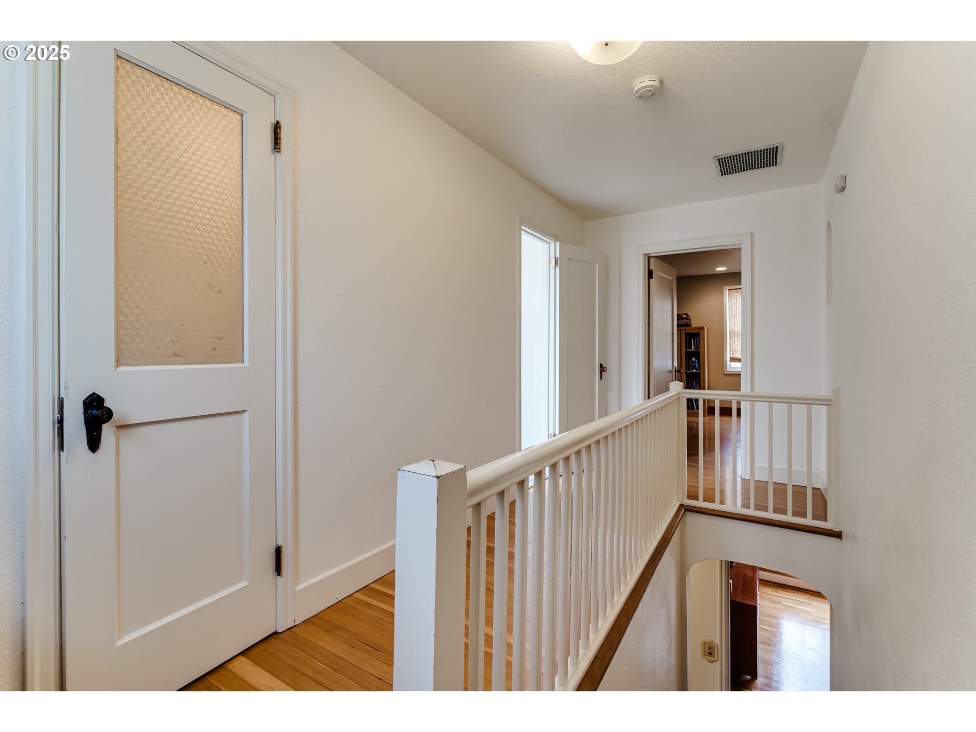 1996 Monroe Street Eugene, OR 97405 - Photo 25 of 47 a view of a hallway with wooden floor and staircase