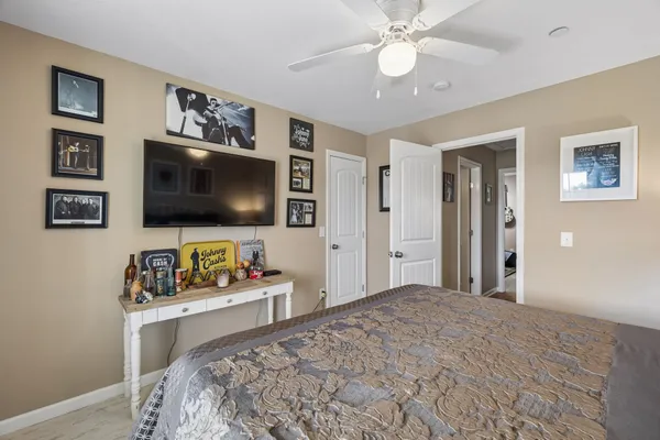 a bedroom with a bed and a flat screen tv